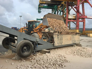 Aggregate material being dumped onto a radial stacker